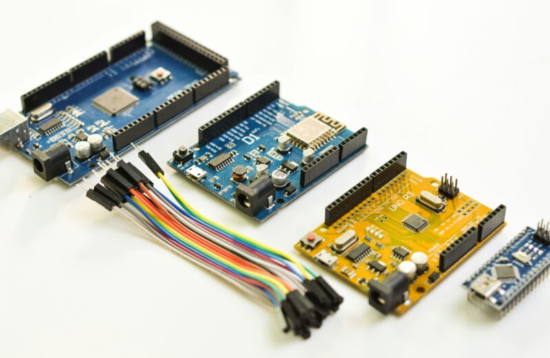 Arduino microcontroller boards with jumper wires for robotics projects
